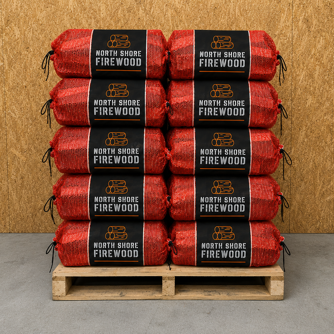 Stack of North Shore Firewood oak nets on a wooden pallet against a wooden wall.