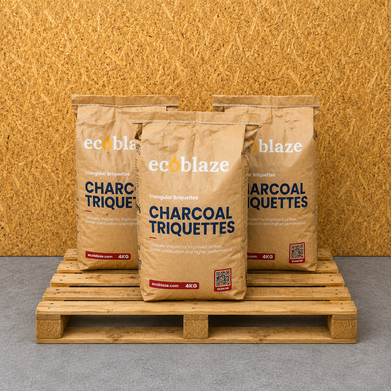 Three bags of ecoblaze Charcoal Triquettes on a wooden pallet with a wooden background.