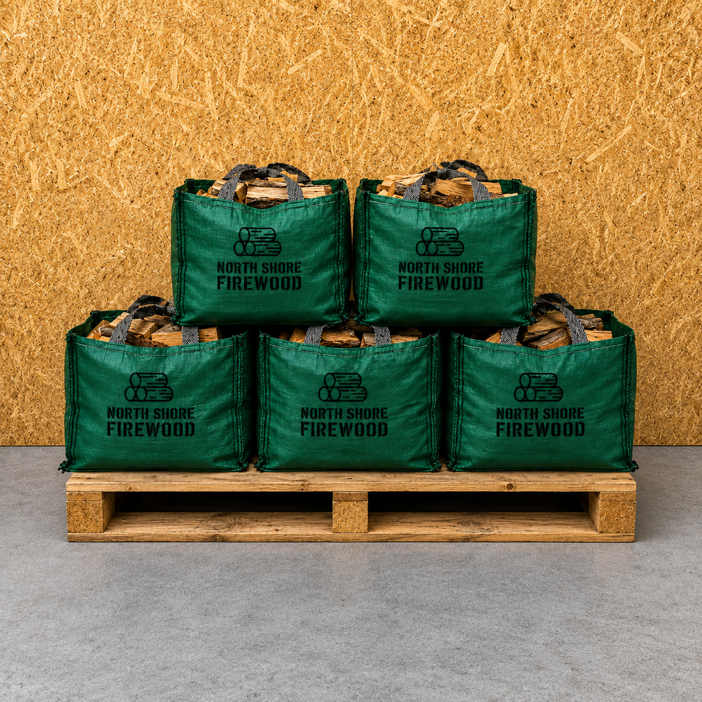Stack of green North Shore Firewood bags on a wooden pallet against a wooden background