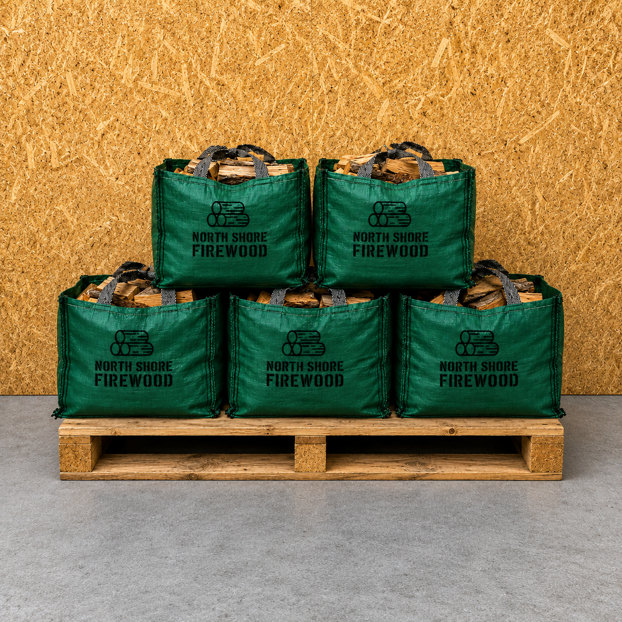 Stack of green North Shore Firewood bags on a wooden pallet against a wooden background