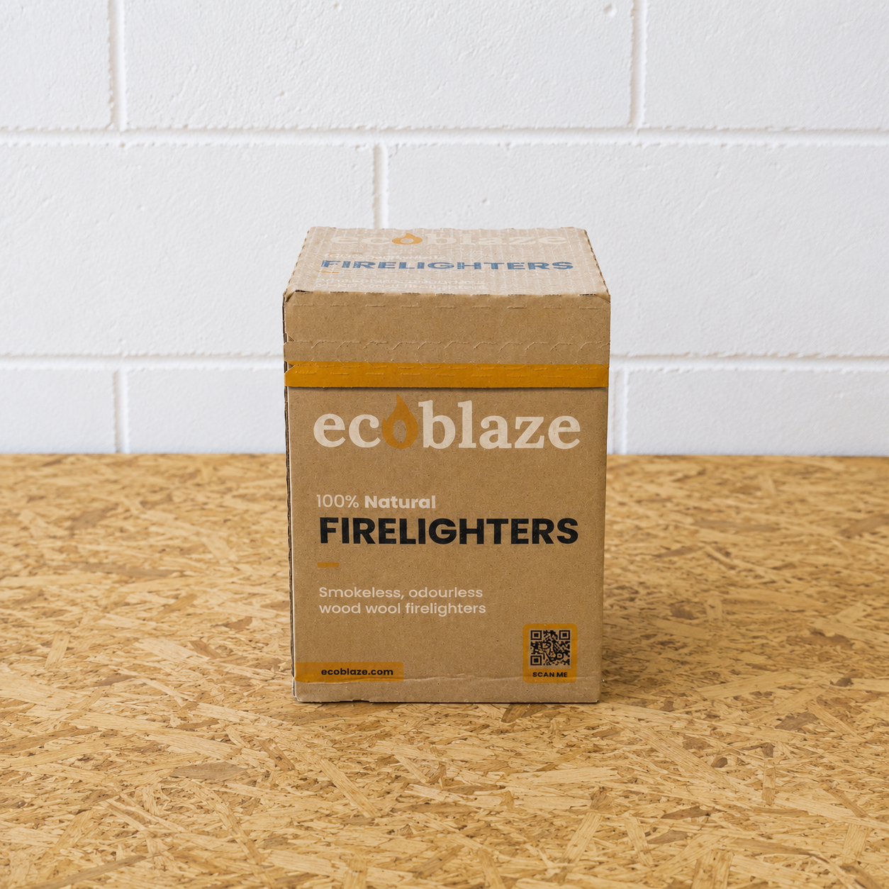 Box of ecoblaze firelighters on a wooden surface with a white tiled wall background