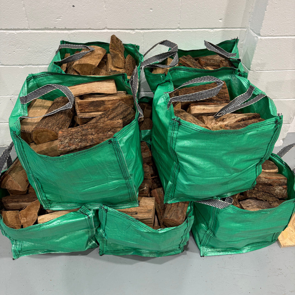 Stack of firewood in green bags against a white wall