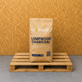 Bag of ecoblaze lumpwood charcoal on a wooden pallet with a wooden background
