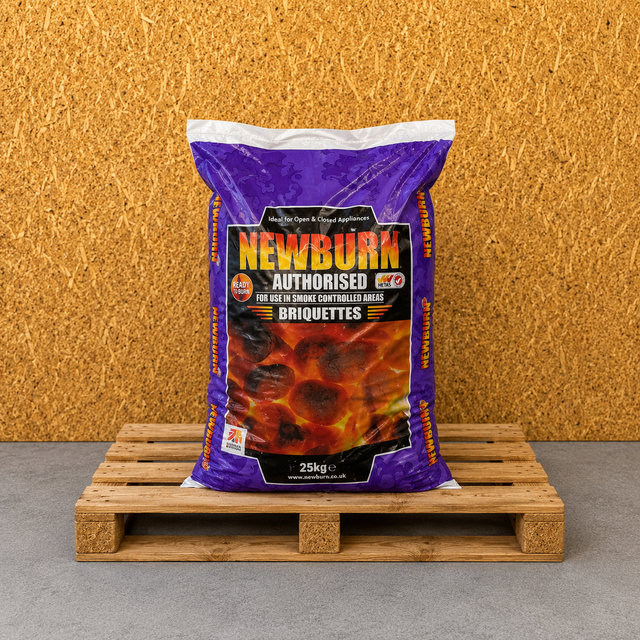 Bag of Newburn briquettes on a wooden pallet with a textured brown wall background